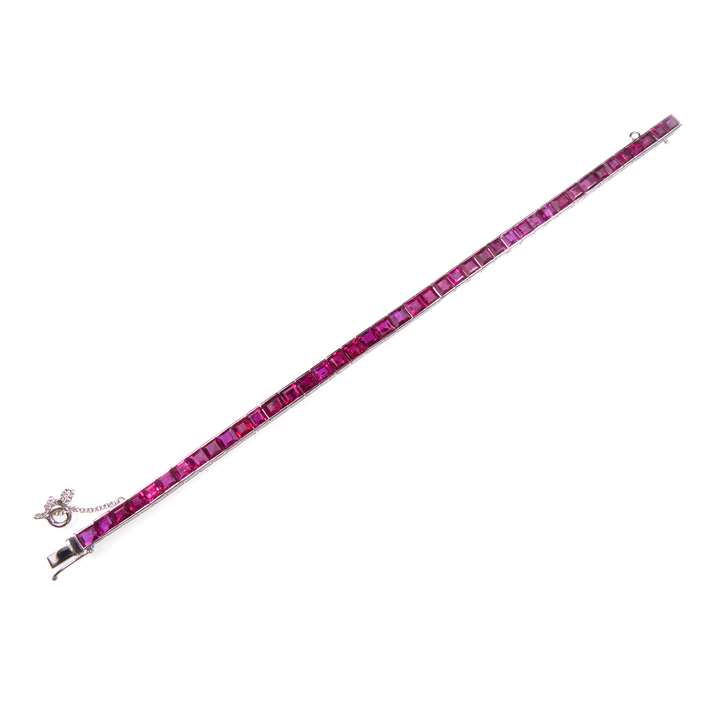 Ruby line bracelet, slightly graduated and channel set with rectangular cut rubies